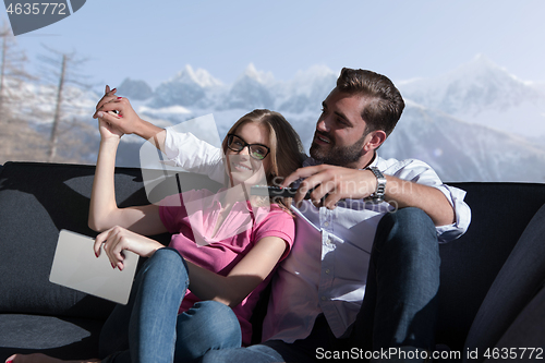 Image of Young couple watching television