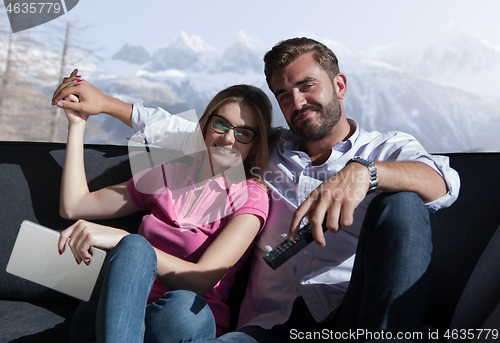 Image of Young couple watching television