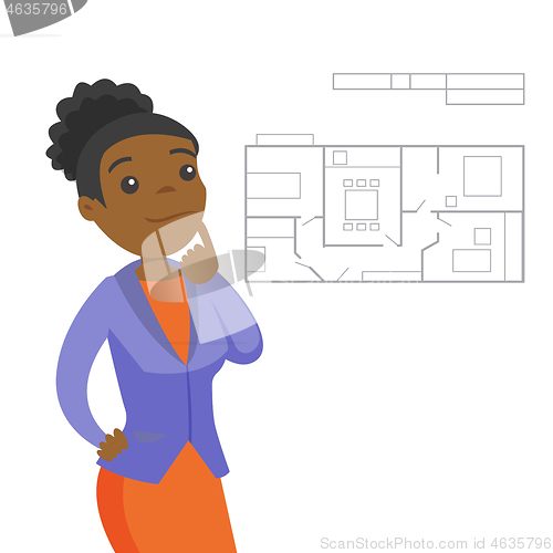 Image of Woman thinking about blueprint of new apartment.