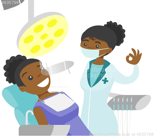 Image of Dentist standing next to the chair with patient.