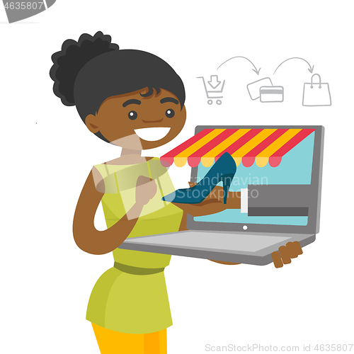 Image of Young african-american woman shopping online.