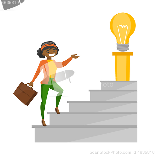 Image of Business woman walking upstairs to the idea bulb.