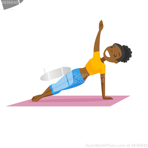 Image of Young african-american woman holding a side plank.