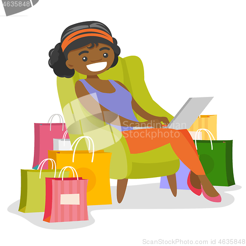 Image of African woman using laptop for online shopping.