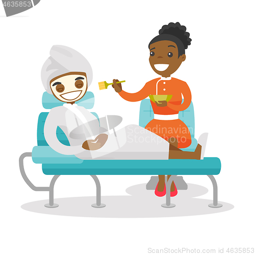 Image of Young woman with cosmetic mask in beauty salon.