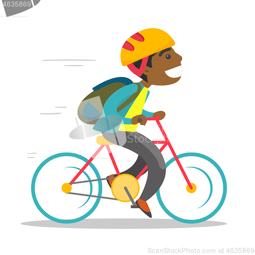 Image of Young african-american boy riding a bicycle.