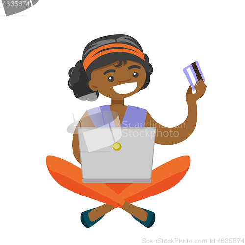 Image of African woman using laptop for online shopping.