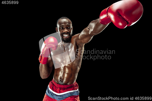 Image of Hand of boxer over black background. Strength, attack and motion concept