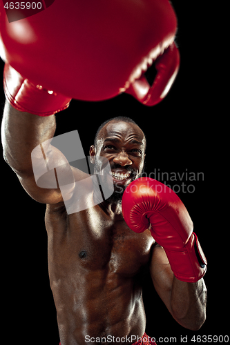 Image of Hand of boxer over black background. Strength, attack and motion concept