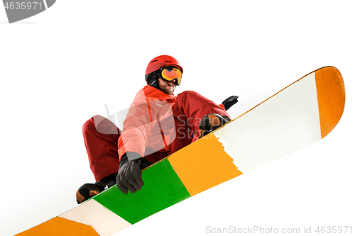 Image of Portrait of young man in sportswear with snowboard isolated on a white background.