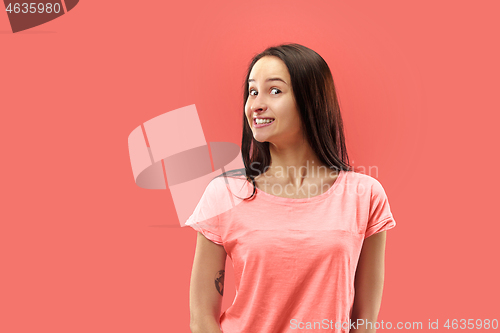 Image of Beautiful woman looking suprised isolated on coral