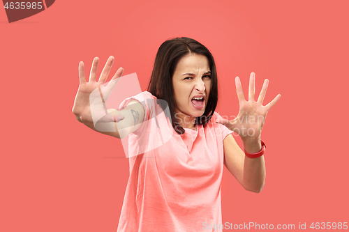 Image of Let me think. Doubtful pensive woman with thoughtful expression making choice against coral background