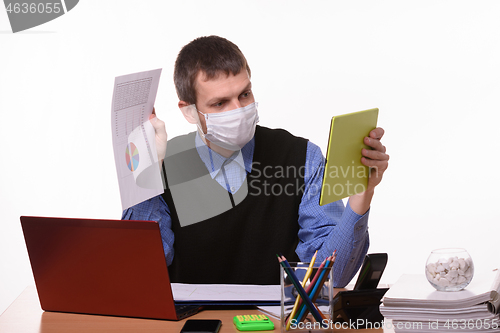 Image of A man in a medical mask shows a paper document with graphs to a virtual interlocutor