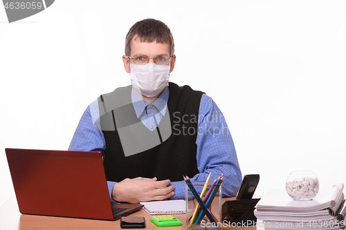 Image of The office clerk from a medical mask sweats glasses