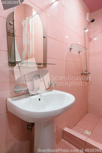 Image of Compact bathtub interior with shower and washbasin