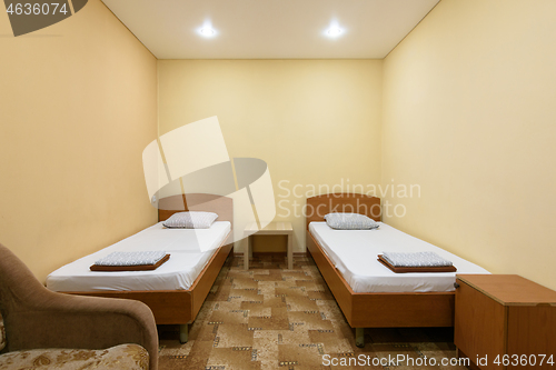 Image of The interior of a budget hotel room with two beds