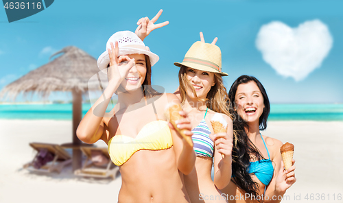 Image of young women in bikini with ice cream on beach