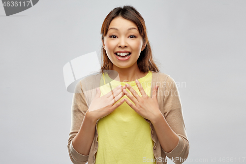 Image of happy asian woman over grey background