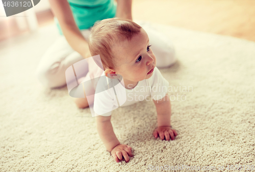 Image of mother with baby on floor at home