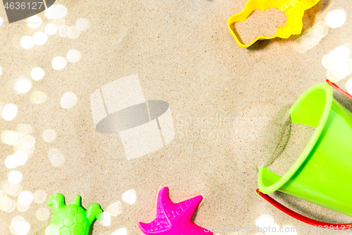 Image of close up of sand toys kit on summer beach