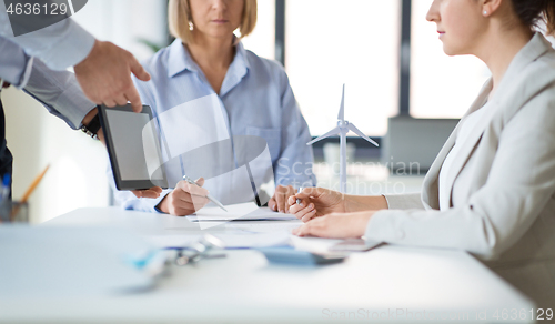 Image of close up of business team with tablet pc at office