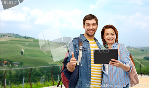 Image of happy couple of tourists with tablet computer