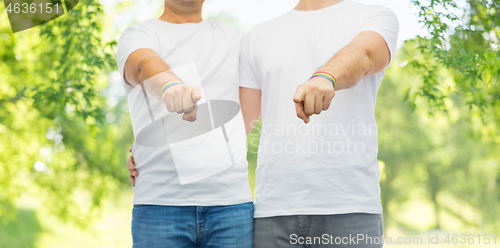 Image of couple with gay pride rainbow wristbands