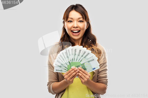Image of asian woman with hundred euro money banknotes