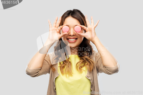 Image of happy asian woman with eyes of macarons