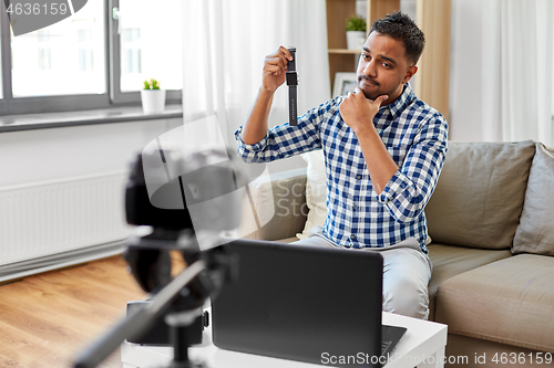 Image of male video blogger with smart watch videoblogging