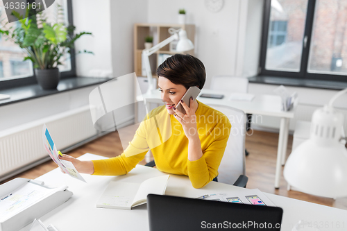 Image of ui designer calling on smartphone at office