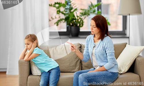 Image of angry mother scolding her daughter at home