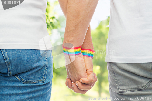 Image of male couple with gay pride rainbow wristbands