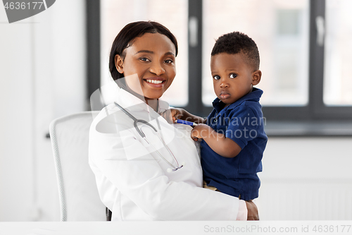 Image of doctor or pediatrician with baby patient at clinic