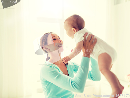 Image of happy young mother with little baby at home