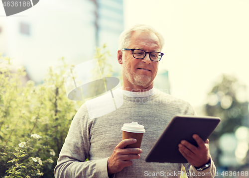 Image of senior man with tablet pc and coffee in city