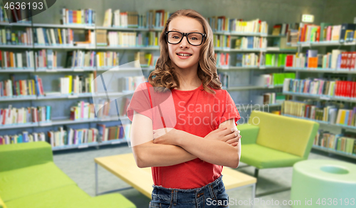 Image of smiling student girl in glasses at library