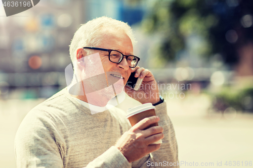 Image of happy senior man calling on smartphone in city