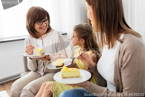 Image of mother, daughter and grandmother eating cake