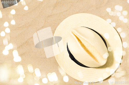 Image of straw hat on beach sand