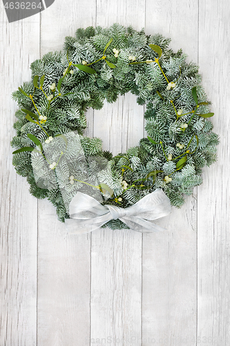 Image of Snow Covered Fir and Mistletoe Wreath