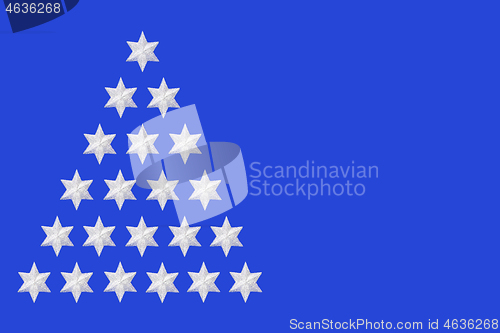 Image of Silver Star Christmas Tree Design on Blue Background