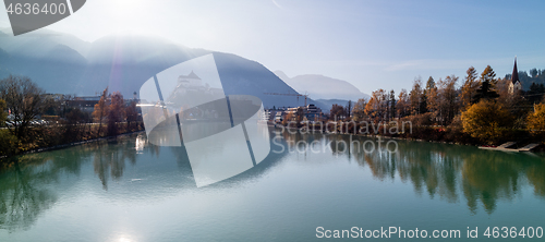 Image of Panoramic view on smooth surface of river before Kufstein Fortress, Austria.