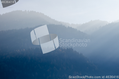 Image of Mountain landscape with forest hills on a background of foggy sky, Kufstein Austria.