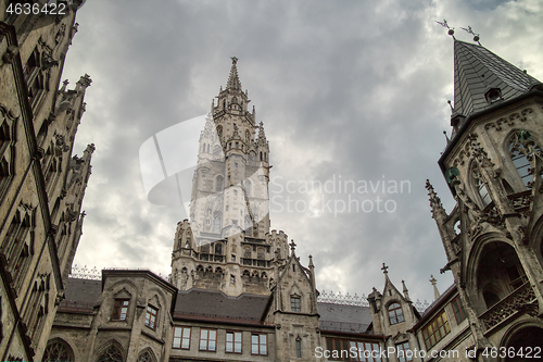 Image of Old-fashioned architectural buildings against grey cloudy sky in Munich, Germany.