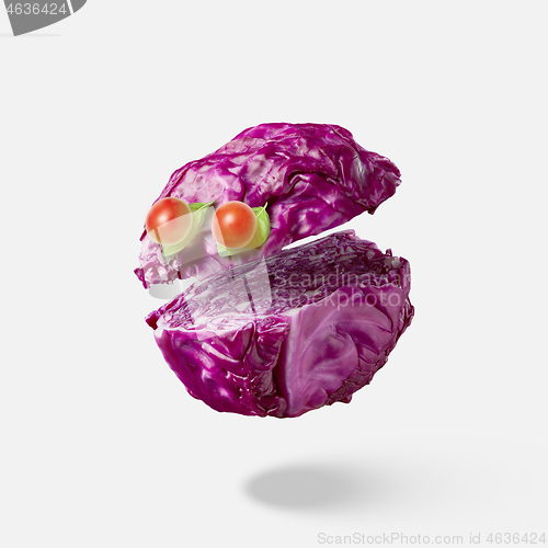 Image of Cut red cabbage as a floating head with eyes from cherry tomatoes.