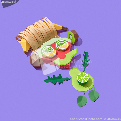 Image of Colorful little man papercraft from fruits listening to music.