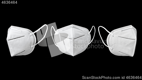 Image of Three medical face masks for protection on a black background.