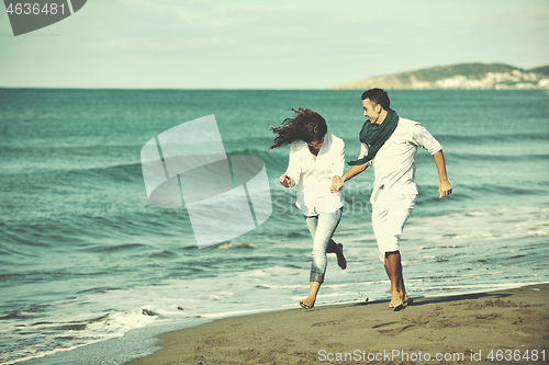 Image of happy young couple have fun at beautiful beach