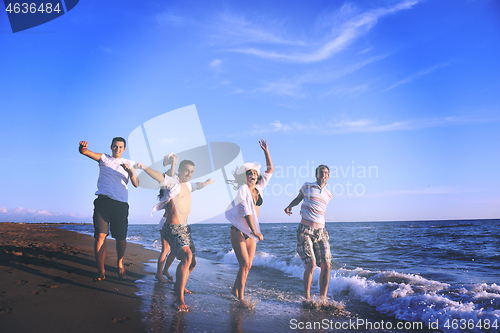 Image of people group running on the beach